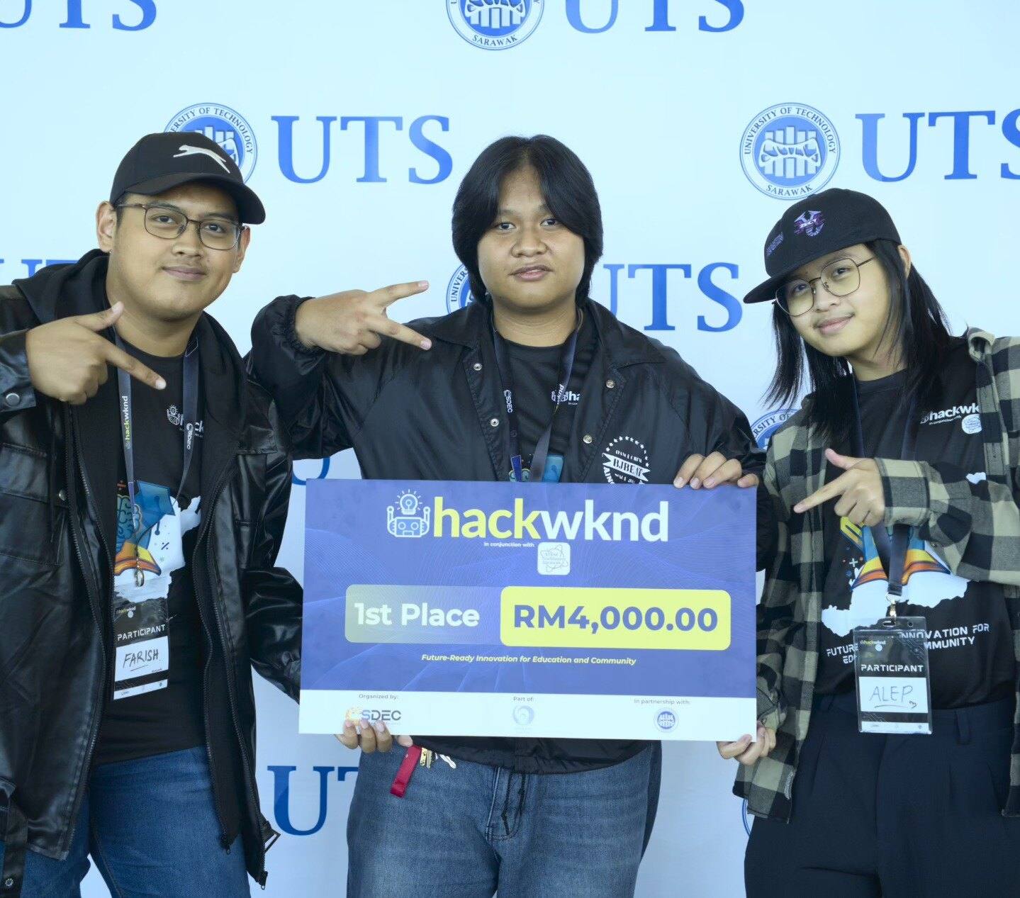 Team TheRookies holding the HackWknd 1st Place mock cheque in front of the UTS backdrop