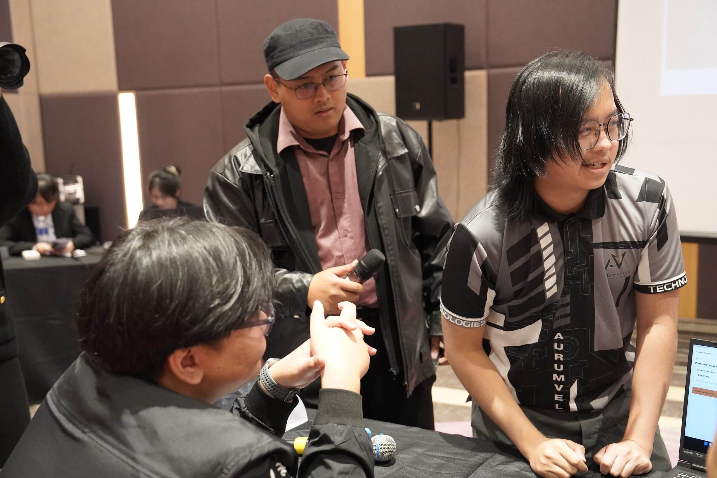 Team members shaking hands with a judge after their demo